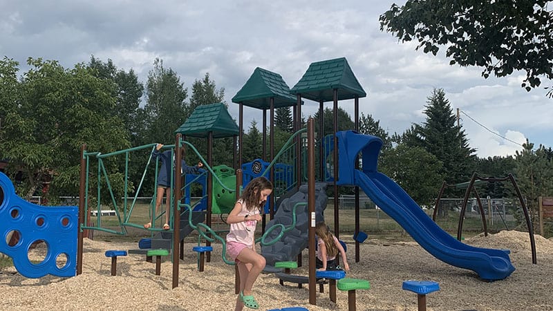 The children playing at the Spring Lake playground on a cloudy day